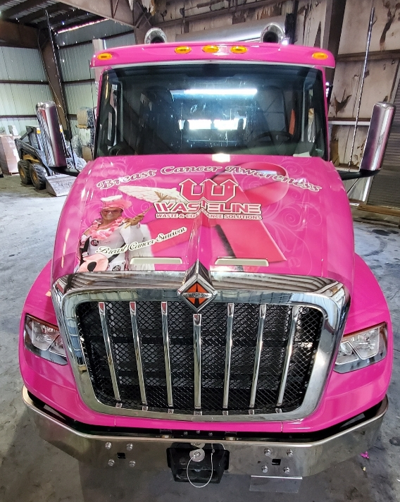 Wasteline Solutions pink roll-off truck