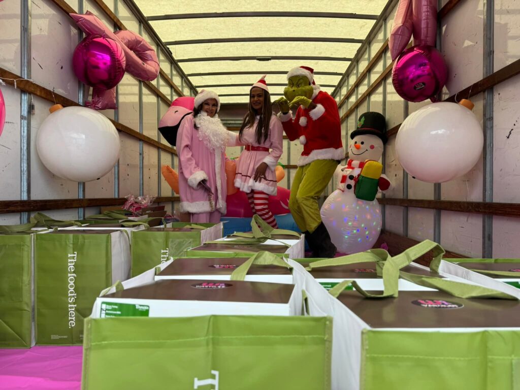 Tina Goldstein at Breast Cancer Awareness Christams Event wearing pink Santa costume with pink elf and The Grinch | Wasteline Solutions